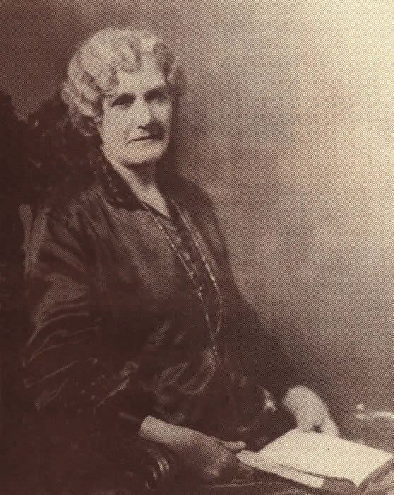 A woman sitting in an old photo.