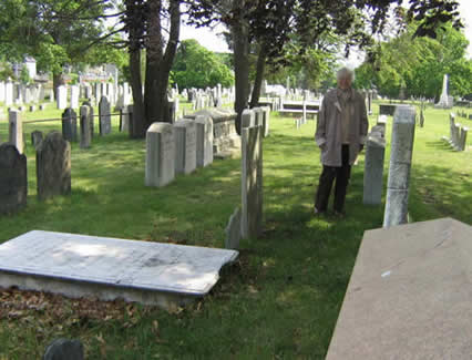 A woman standing in front of some graves
